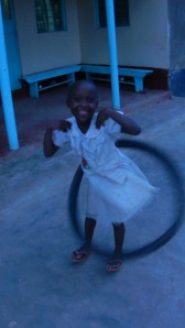 Joy with a bike tire "hulahoop".  No...her name is Joy.